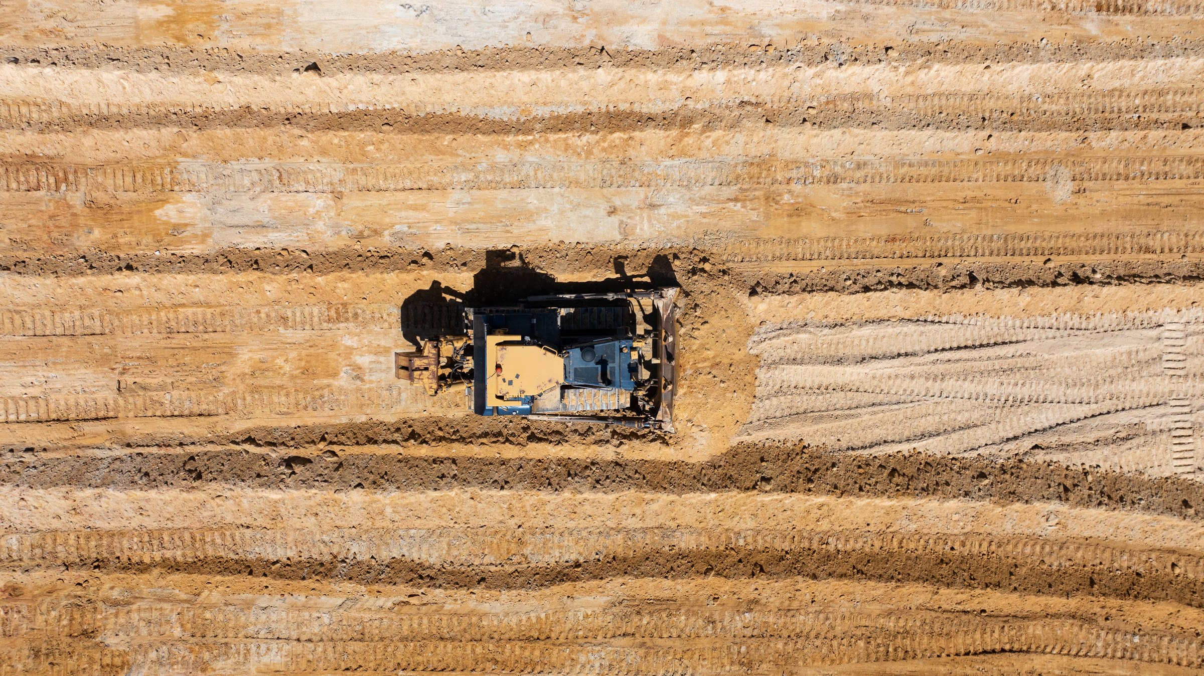 Aerial view of a dozer working the sand at MRP Sand Quarry, Talgai QLD